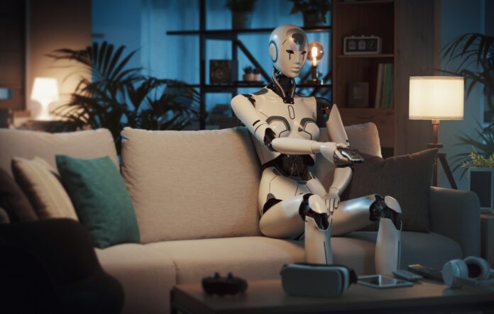 Humanoid robot sitting on the couch and watching TV